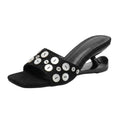 ZQW Button Chunky Mules in black, 45-degree angle view – sculptural curved heel, open square toe, statement button detail, backless slip-on vegan leather mule