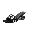 ZQW Button Chunky Mules in black, 45-degree angle view – sculptural curved heel, open square toe, statement button detail, backless slip-on vegan leather mule