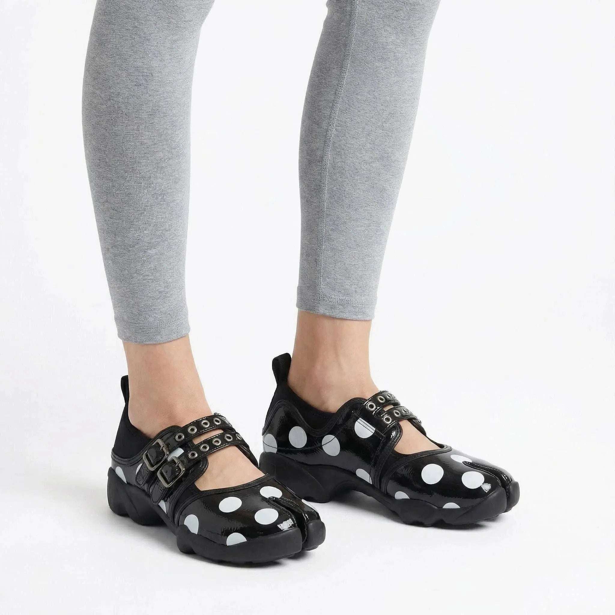 ZQW Dotty Split 1.0 black big dot sneakers worn on feet – bold polka dot pattern makes a statement, split-toe fit, Mary Jane strap for secure hold, cushioned insole for comfort