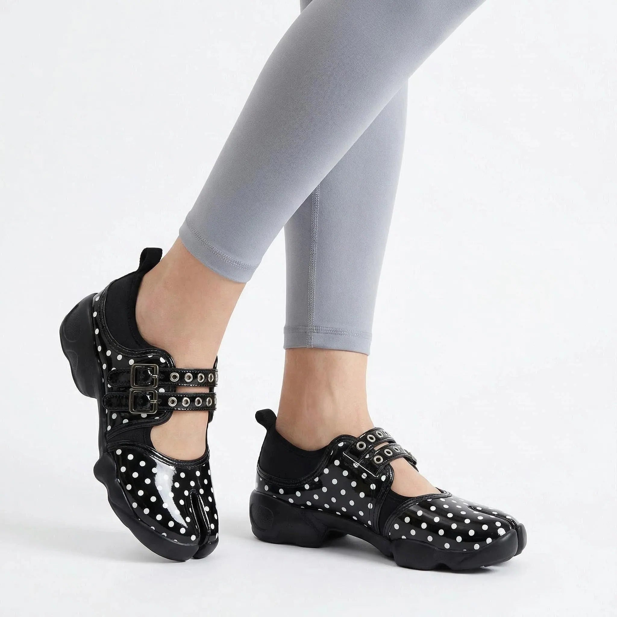 ZQW Dotty Split 1.0 black small dot sneakers worn on feet – delicate polka dot pattern adds playful detail, split-toe fit, Mary Jane strap for secure hold, cushioned insole for comfort