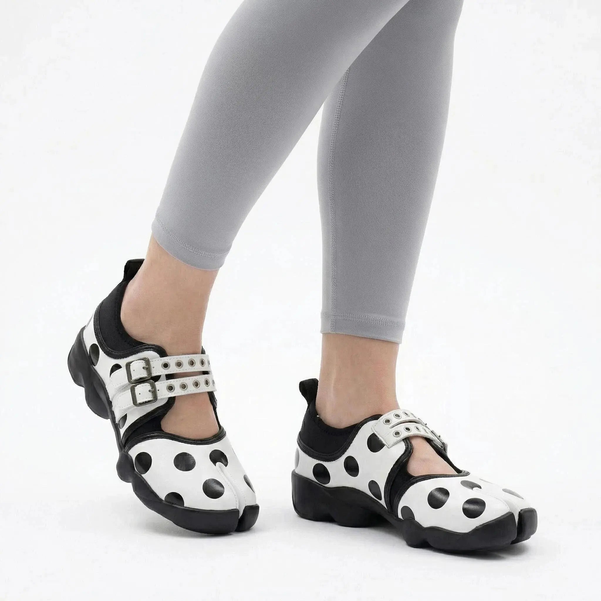 ZQW Dotty Split 1.0 white big dot sneakers worn on feet – bold polka dot pattern makes a statement, split-toe fit, Mary Jane strap for secure hold, cushioned insole for comfort