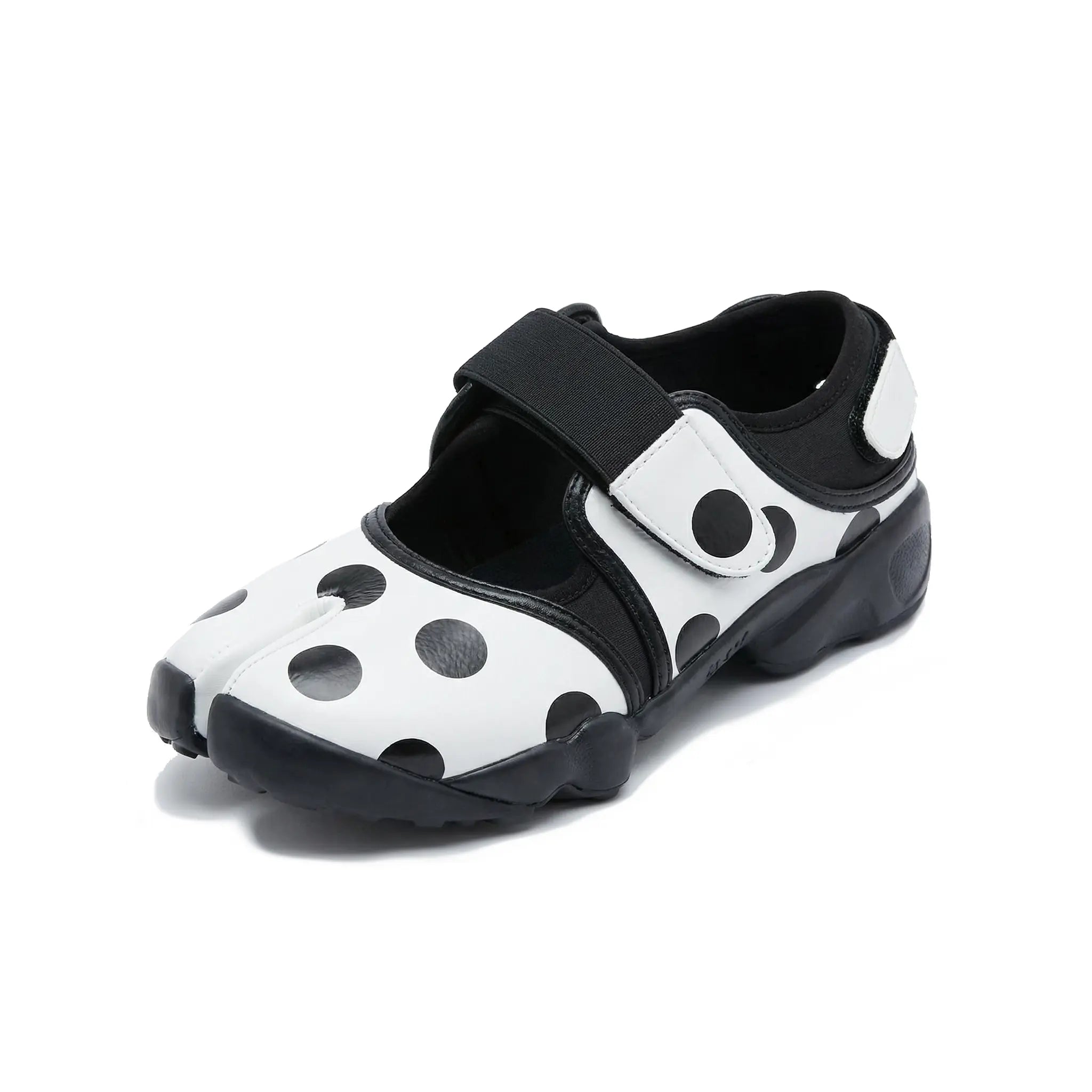 ZQW Dotty Split 2.0 Tabi Mary Jane Sneakers in white with bold polka dots, 45-degree angle view – chunky black dots on white base, split-toe design, hook & loop closure, cushioned sneaker sole