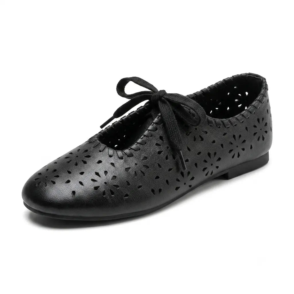 ZQW Lace-Up Cutout Floral Mary Janes in black, 45-degree angle view – laser-cut flower pattern, lace-up front closure, round toe, breathable ballet flat