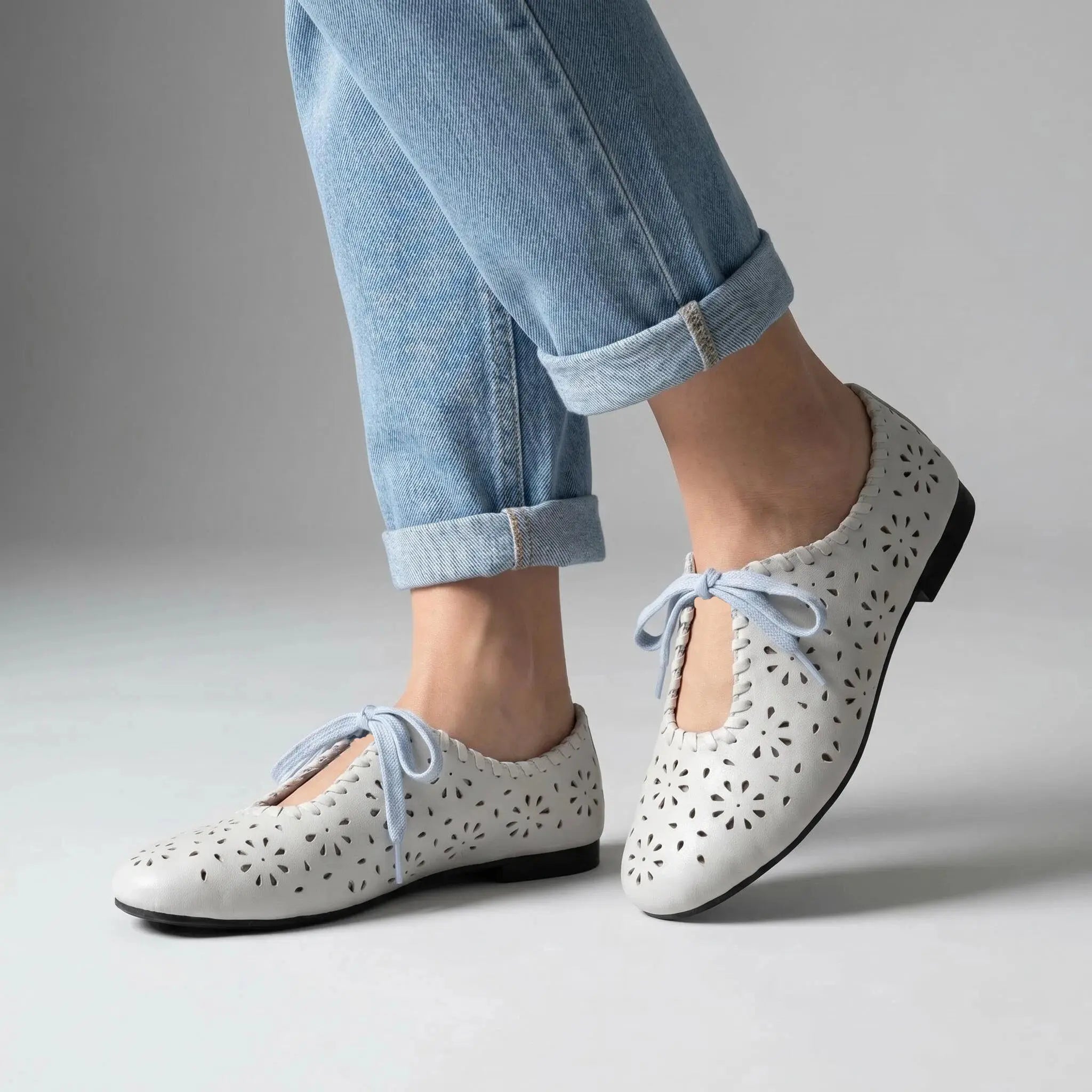 ZQW Lace-Up Cutout Floral Mary Janes in blue, worn on feet close-up – floral cutout pattern allows breathability, lace-up front for adjustable fit, cushioned insole for all-day comfort