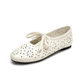 ZQW Lace-Up Cutout Floral Mary Janes in white, 45-degree angle view – laser-cut flower pattern, lace-up front closure, round toe, breathable ballet flat