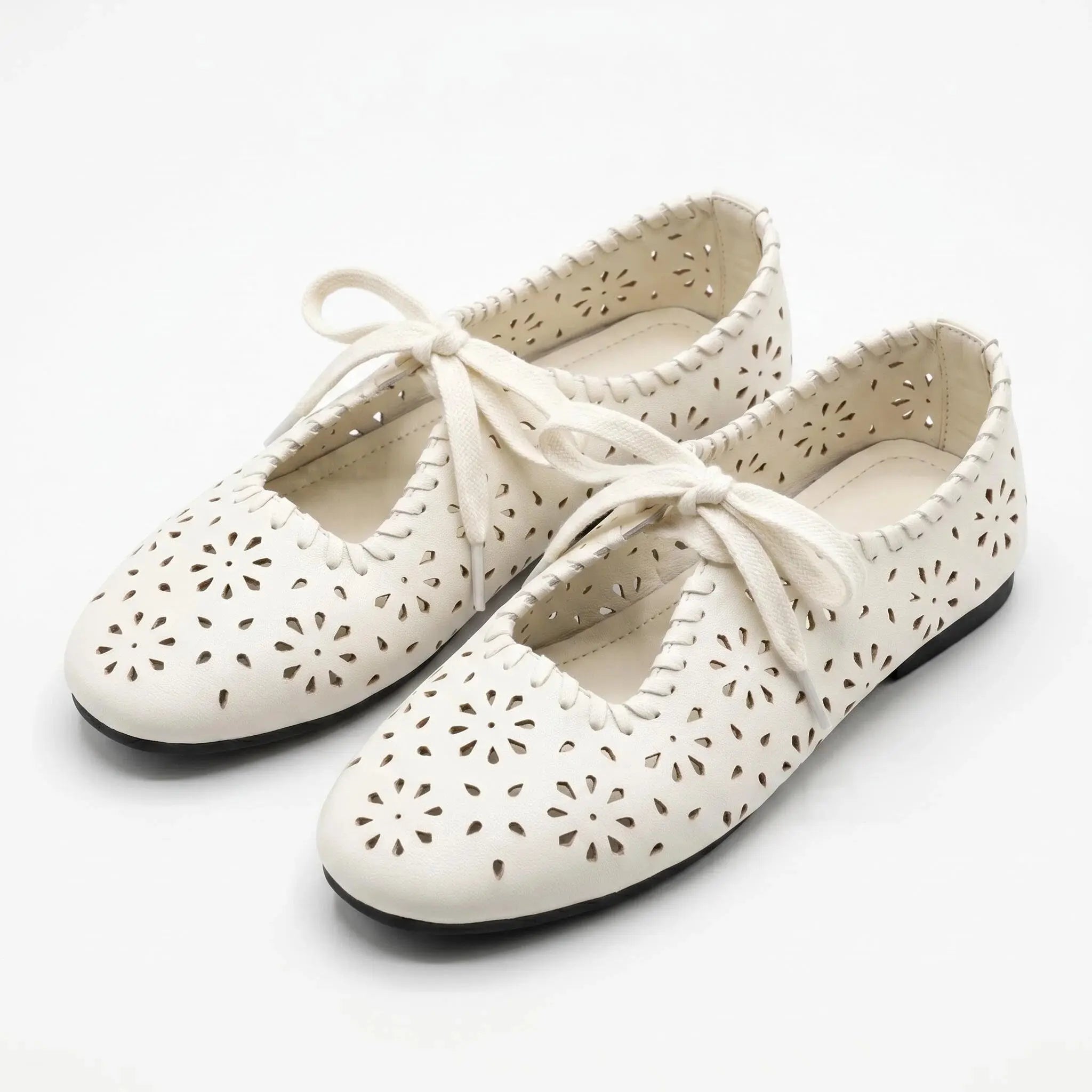 ZQW Lace-Up Cutout Floral Mary Janes in white, model wearing – cute floral cutout Mary Jane flats with lace-up detail, comfortable and breathable for everyday wear