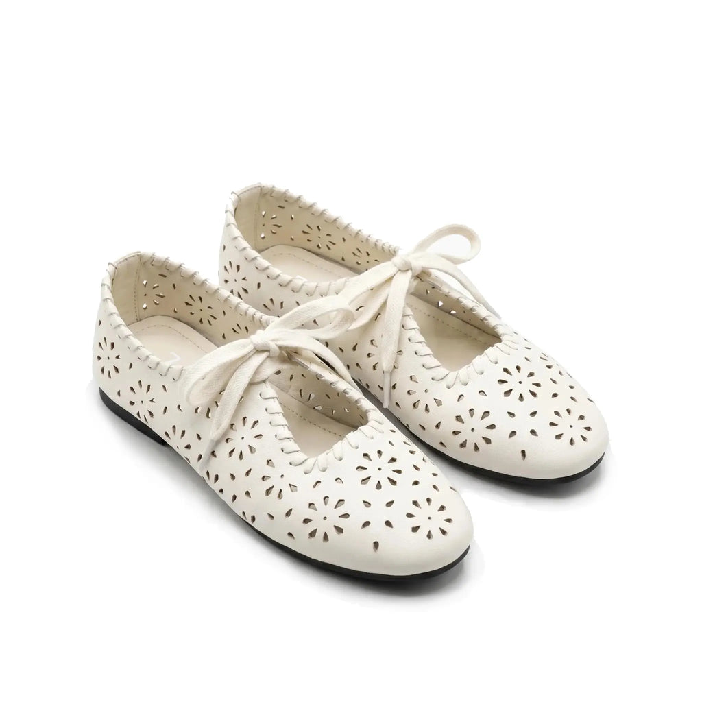 ZQW Lace-Up Cutout Floral Mary Janes in white, model wearing – cute floral cutout Mary Jane flats with lace-up detail, comfortable and breathable for everyday wear