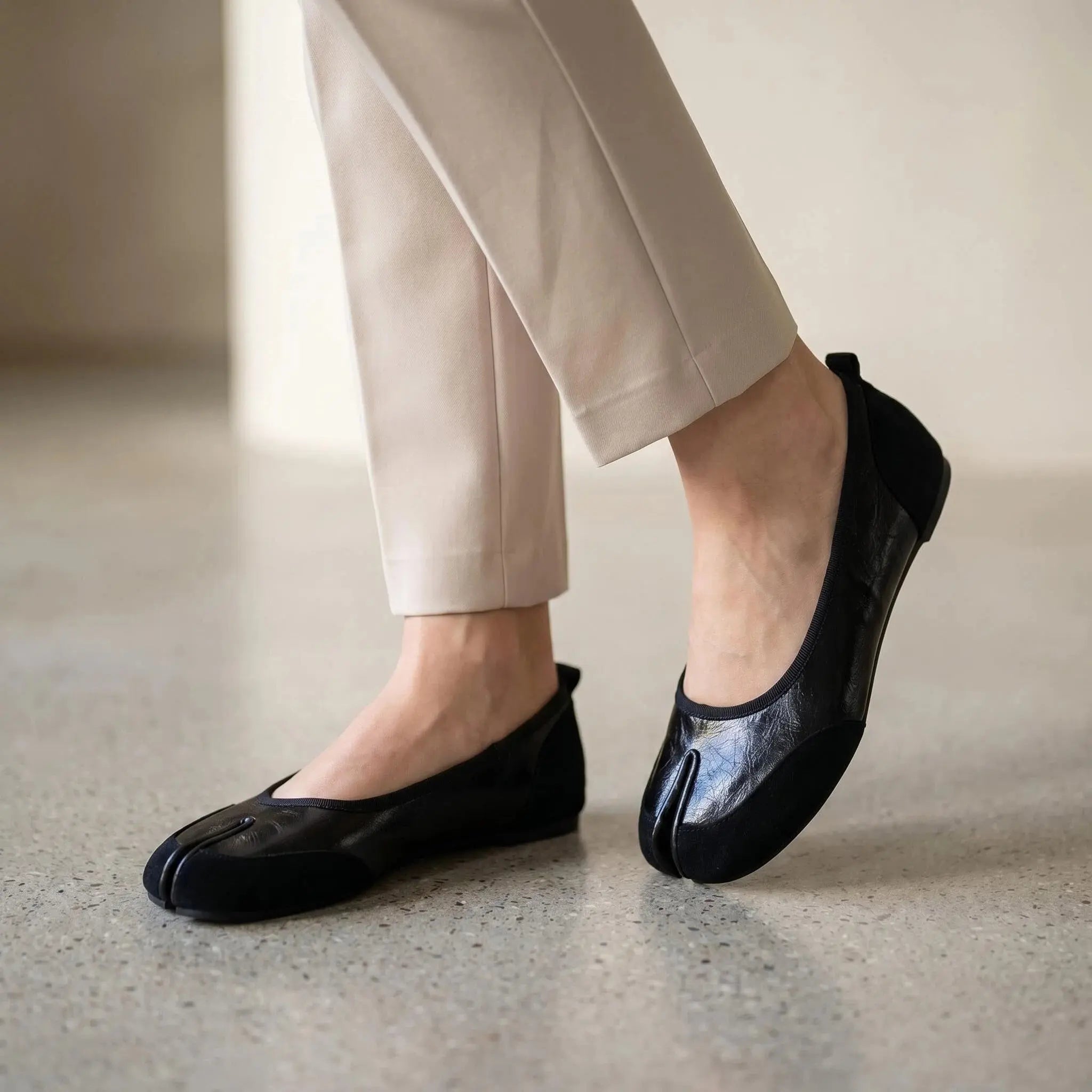 ZQW Mixed Media Tabi Flats in black, worn on feet close-up – split-toe fit allows natural movement, mixed material texture, cushioned insole for all-day comfort