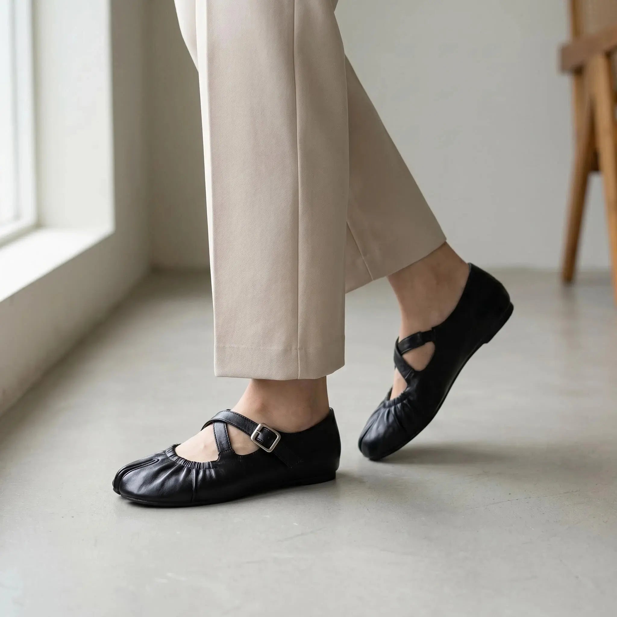 ZQW Ruched Tabi Mary Janes in black, worn on feet close-up – cross strap with elastic connector provides flexible fit, split toe allows natural movement, cushioned insole