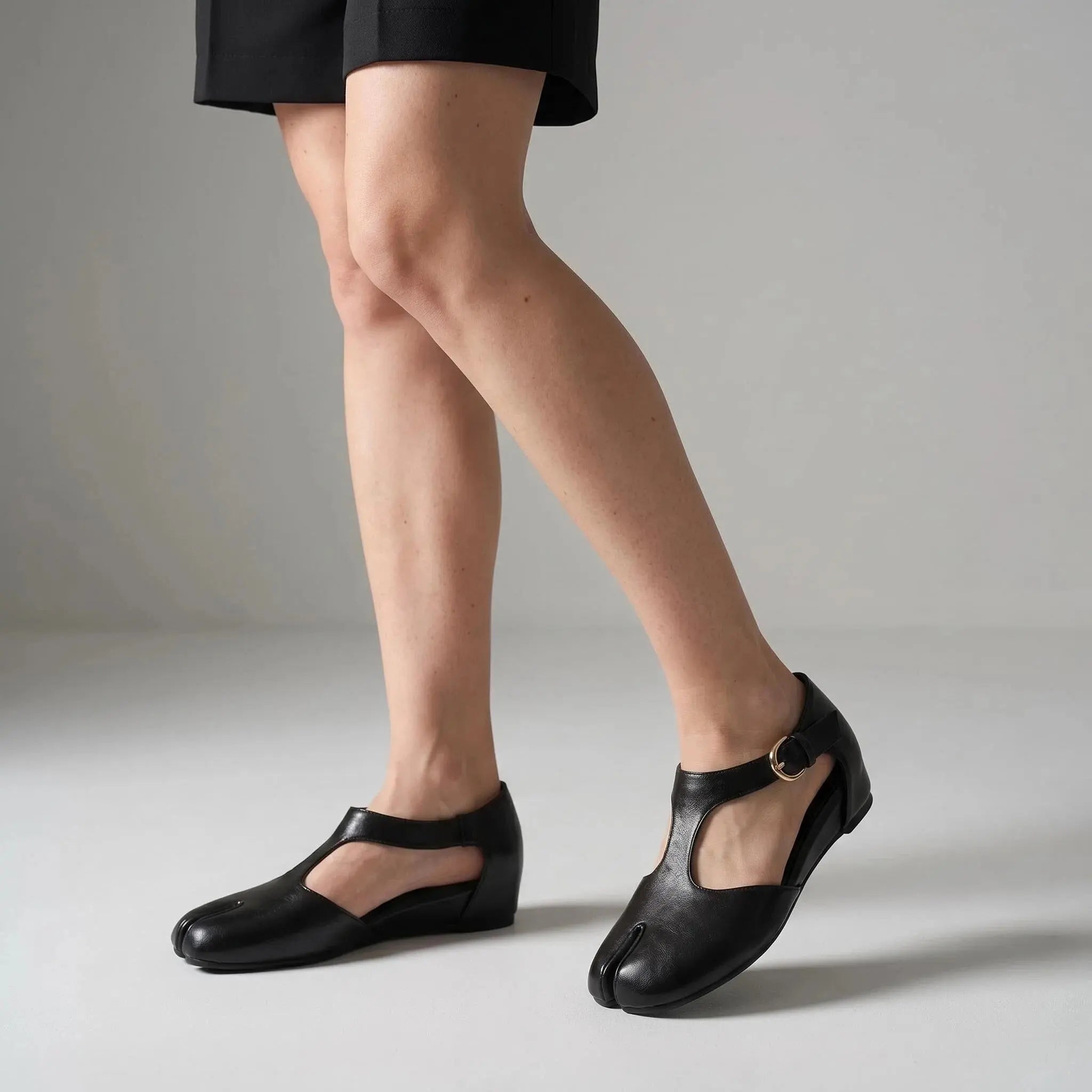 ZQW Tabi Mary Jane Flats in black, worn on feet close-up – T-strap secured with buckle, side cutouts allow airflow, split-toe freedom, all-day comfort